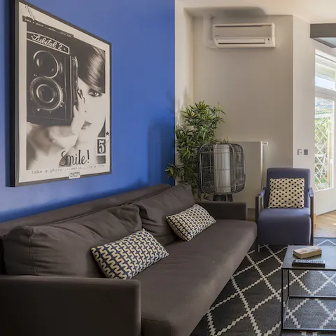 Relax in the living space with its electric blue walls and vintage posters