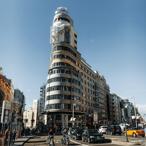 Stay on the famous Gran Via among grand architecture and historic cinemas