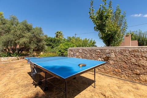 Play table tennis with loved ones as the sun warms your skin