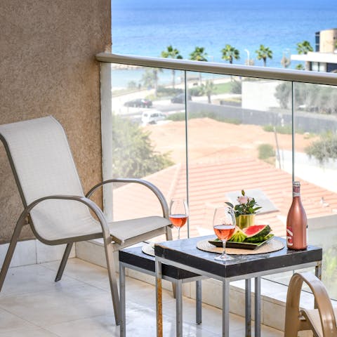 Enjoy a drink with a view from your private balcony as the sea stretches out before you