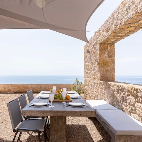 Enjoy a spread of sumptuous Greek dishes on your private terrace