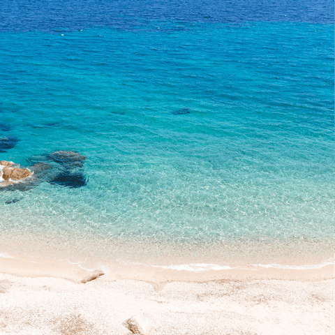 Spend a day on the sands of Agios Stefanos Beach, a short drive away