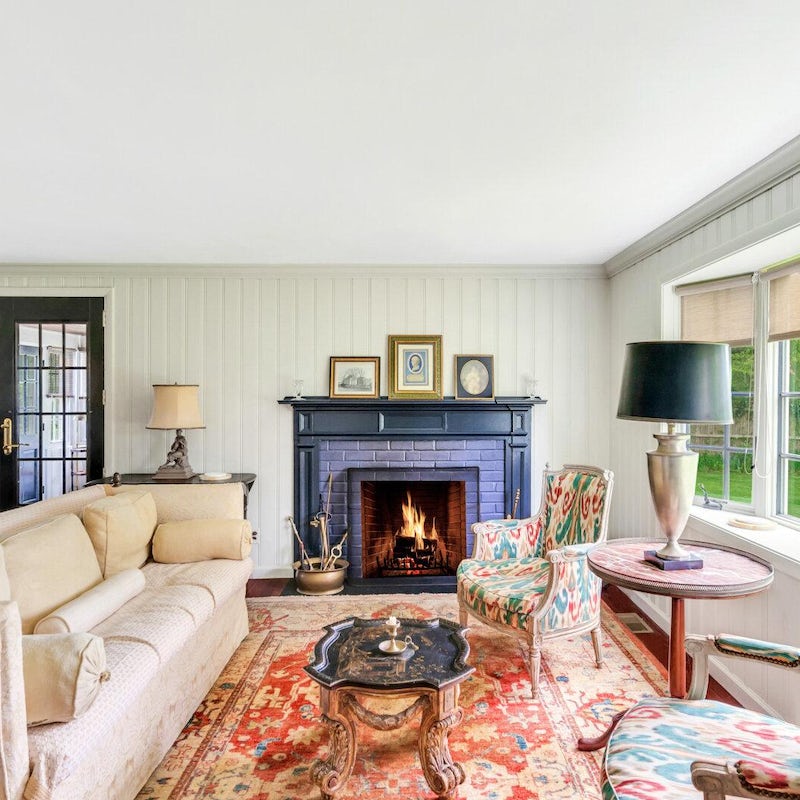 Snuggle up by the living room's fire with a glass of wine on cooler evenings