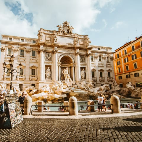 Toss a coin over your shoulder into the Trevi Fountain, 650m away