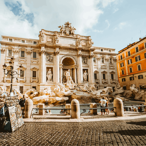 Toss a coin over your shoulder into the Trevi Fountain, 650m away