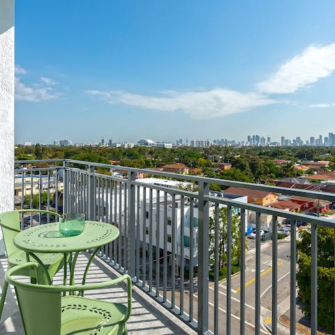 Enjoy a drink with a view towards the city on the balcony