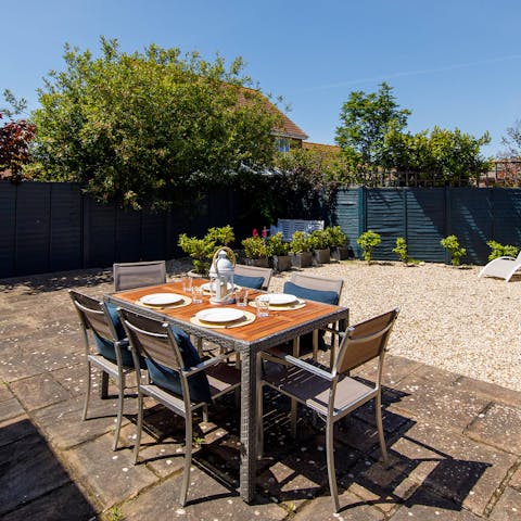Gather around the outdoor dining table for a hearty barbecued dinner, washed down with Pimms