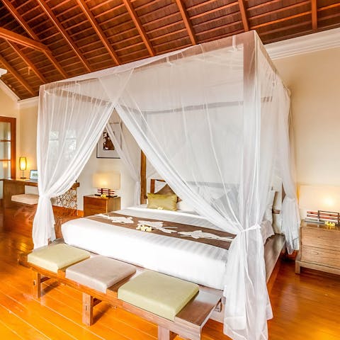 Watch the light curtains dance in a gentle breeze as you relax in the four poster bed
