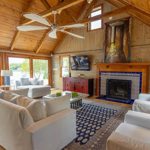 Admire the vaulted wood beam ceiling and tiled fireplace as you relax in the living room