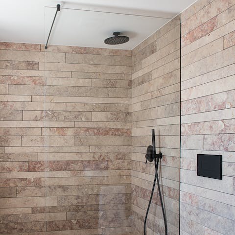 Freshen up in style under the rainfall shower in the modern bathroom