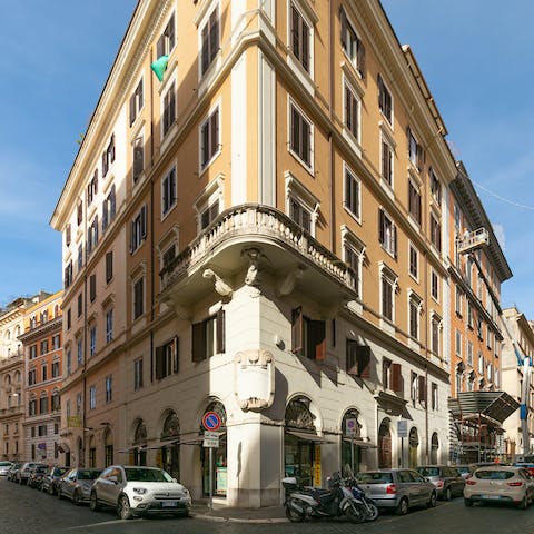 Admire the traditional facade of your striking building on the corner of the block