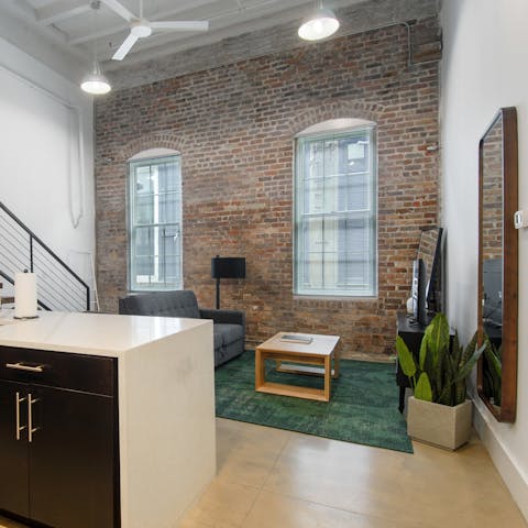 Admire restored features like the reclaimed wooden floors and exposed brick walls