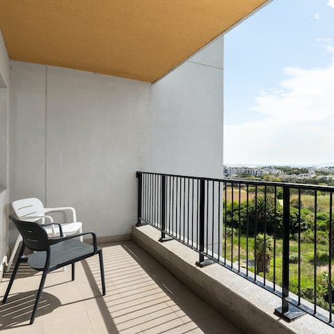 Admire views of Intaka Island from the private balcony