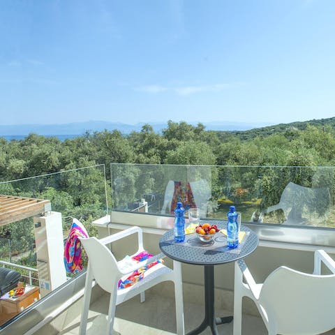 Gaze out at the Ionian Sea and Albanian mountains on the balcony