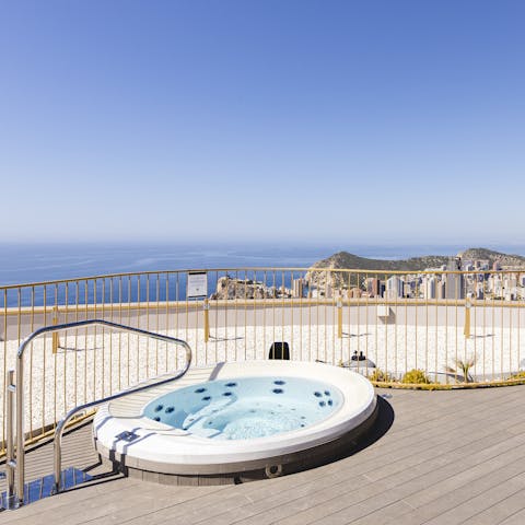 Admire panoramic views of the Costa Blanca shore from a shared hot tub