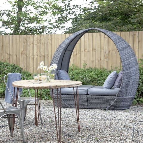 Relax on the daybed with a good book while catching some rays 