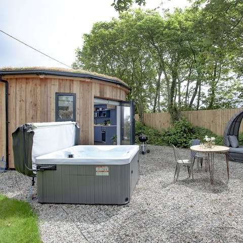 Enjoy a long soak in the private hot tub, a glass of bubbly in hand