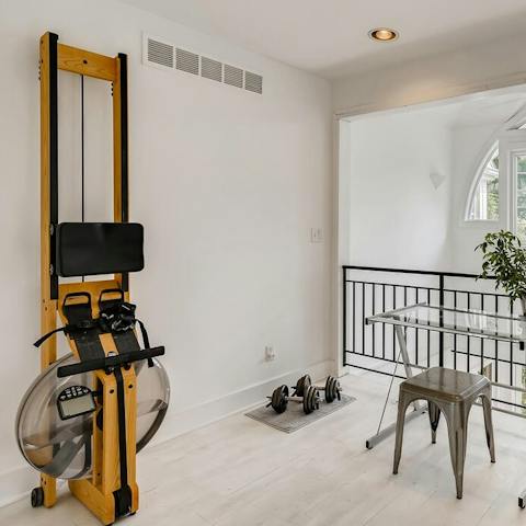 Work out with the rowing machine and weights in the upstairs workspace