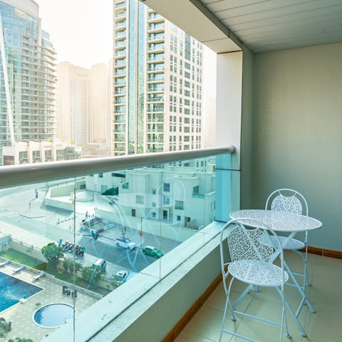 Step onto the balcony and savour the views with a refreshing drink in hand