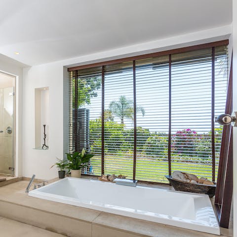 Enjoy a long soak in the sunken bathtub complete with a verdant view