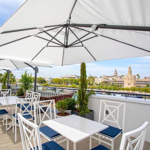 Drink in views of Torre del Oro with a glass of wine on the shared roof terrace