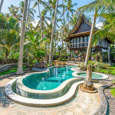Enjoy the glistening pool and lush tropical garden 
