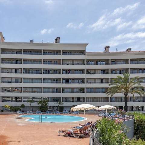 While away sunny afternoons relaxing by the communal pool