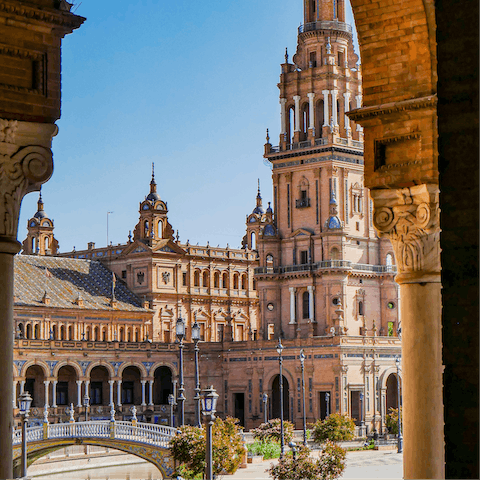 Stroll around the majestic Plaza de España, a bus ride away 