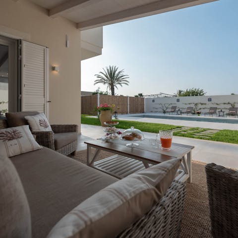 Sip on a sundowner while you sink into your outdoor sofa, watching the blue sky twist into shades of orange and red