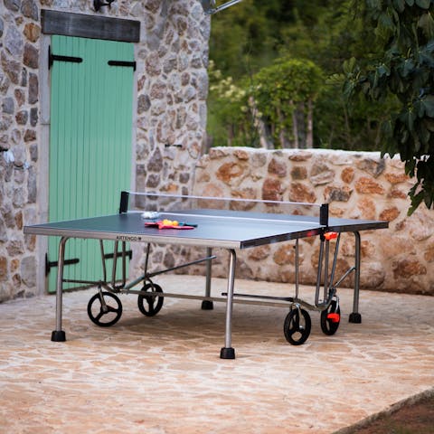 Take on a rival at a game of outdoor table tennis