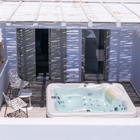 Sink into the outdoor hot tub for a long, luxurious soak