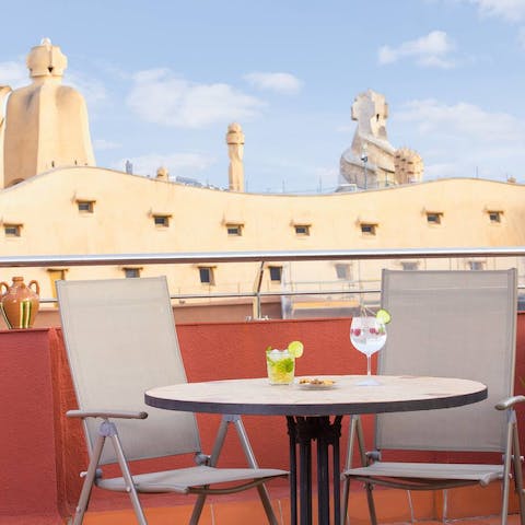 Savour cocktails on the terrace as you look out to the rooftop of Casa Milà