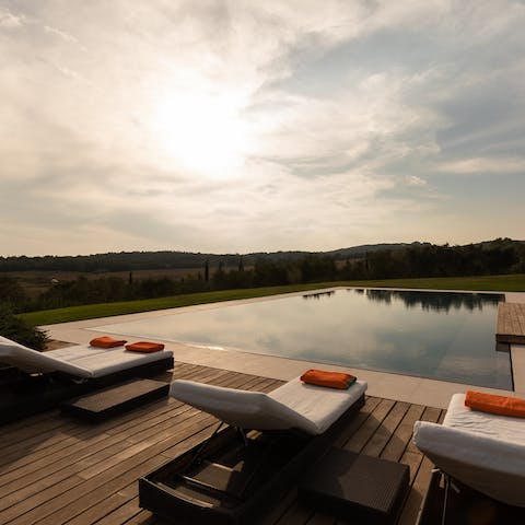Watch the sunset while you sip on a glass of bubbly by the pool