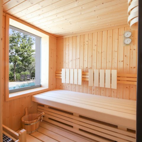 Achieve total relaxation in the private sauna with pool views