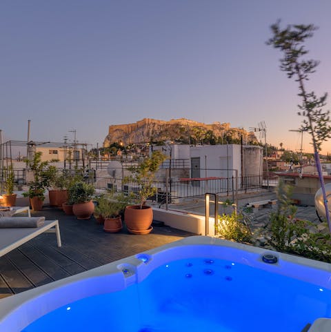 Admire the Acropolis rising above the city from the wamth of the private hot tub