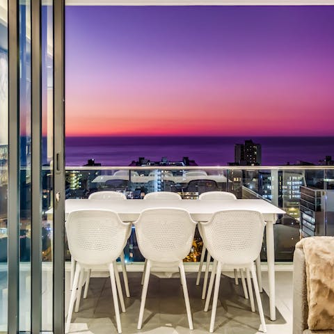 Tuck into tasty South African cuisine while gazing out at the sunset from the terrace dining table