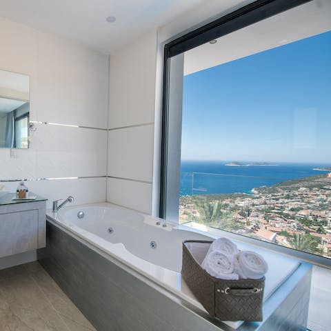 Treat yourself to a languorous soak in the bathtub next to the floor-to-ceiling window