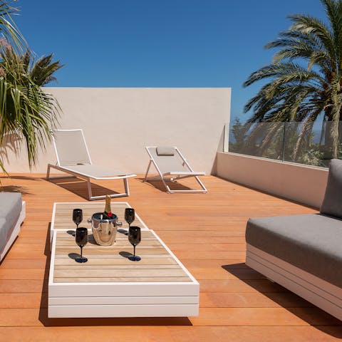 Sip sundowners on the villa's stunning rooftop terrace