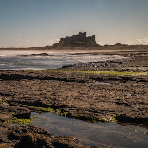 Stroll down to Seahouses Harbour for fish and chips by the water and views of Bamburgh Castle