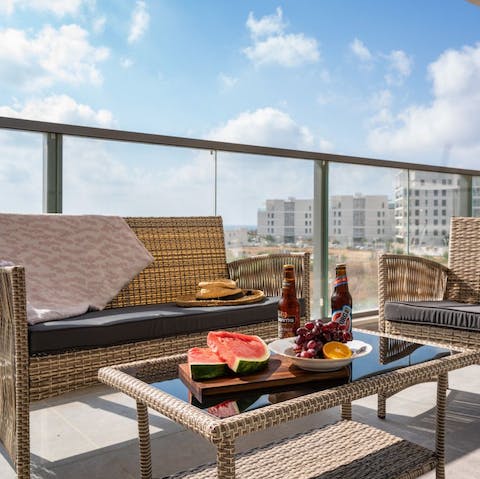 Watch a sunset over the Nahariya townscape from your private balcony