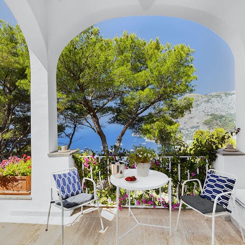 Share an aperitivo on the terrace shaded by the arches