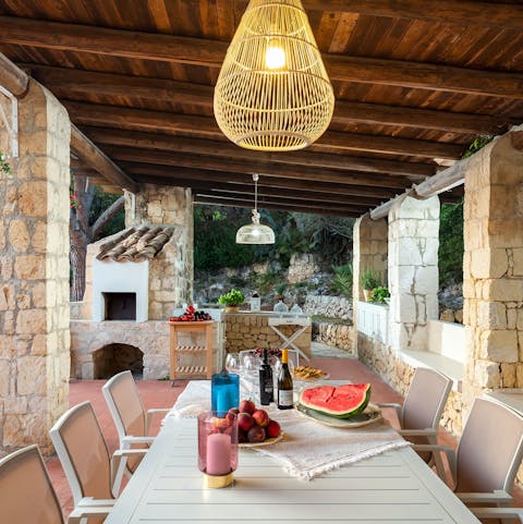 Tuck into freshly barbecued Sicilian produce at the alfresco dining table