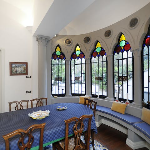 Squeeze in around the dining table for breakfast under the stained glass windows