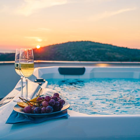 Relax in the private hot tub as the sun goes down