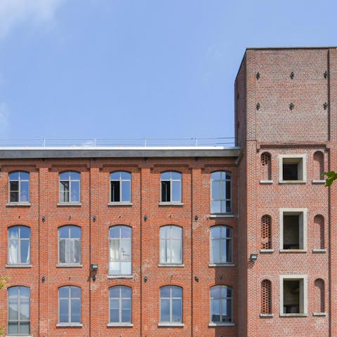Admire the majestic exterior of this former factory, in original red brick
