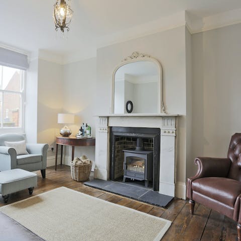 Relax in the living room where the original fireplace now holds a cosy wood-burner