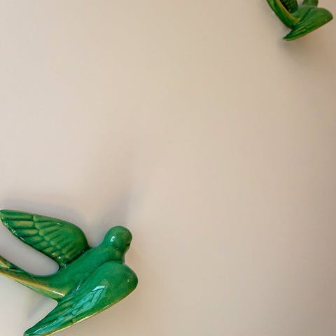 Admire quirky design touches like the birds on the bedroom wall