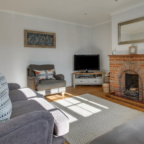 Kick back and relax in front of the fire in the cosy living room 