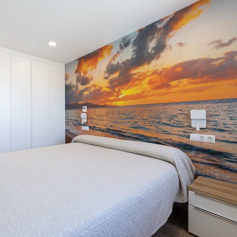 Snuggle up for an afternoon siesta in the bedroom, surrounded by the sunset mural