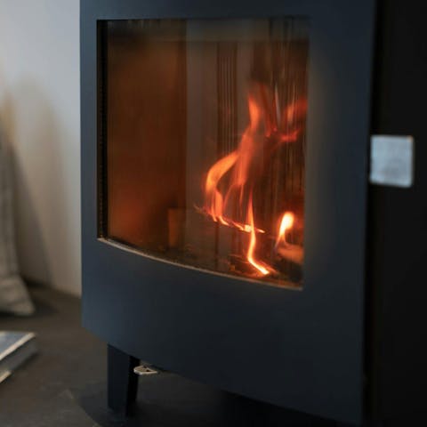 Pour a glass of wine and unwind beside the log burner